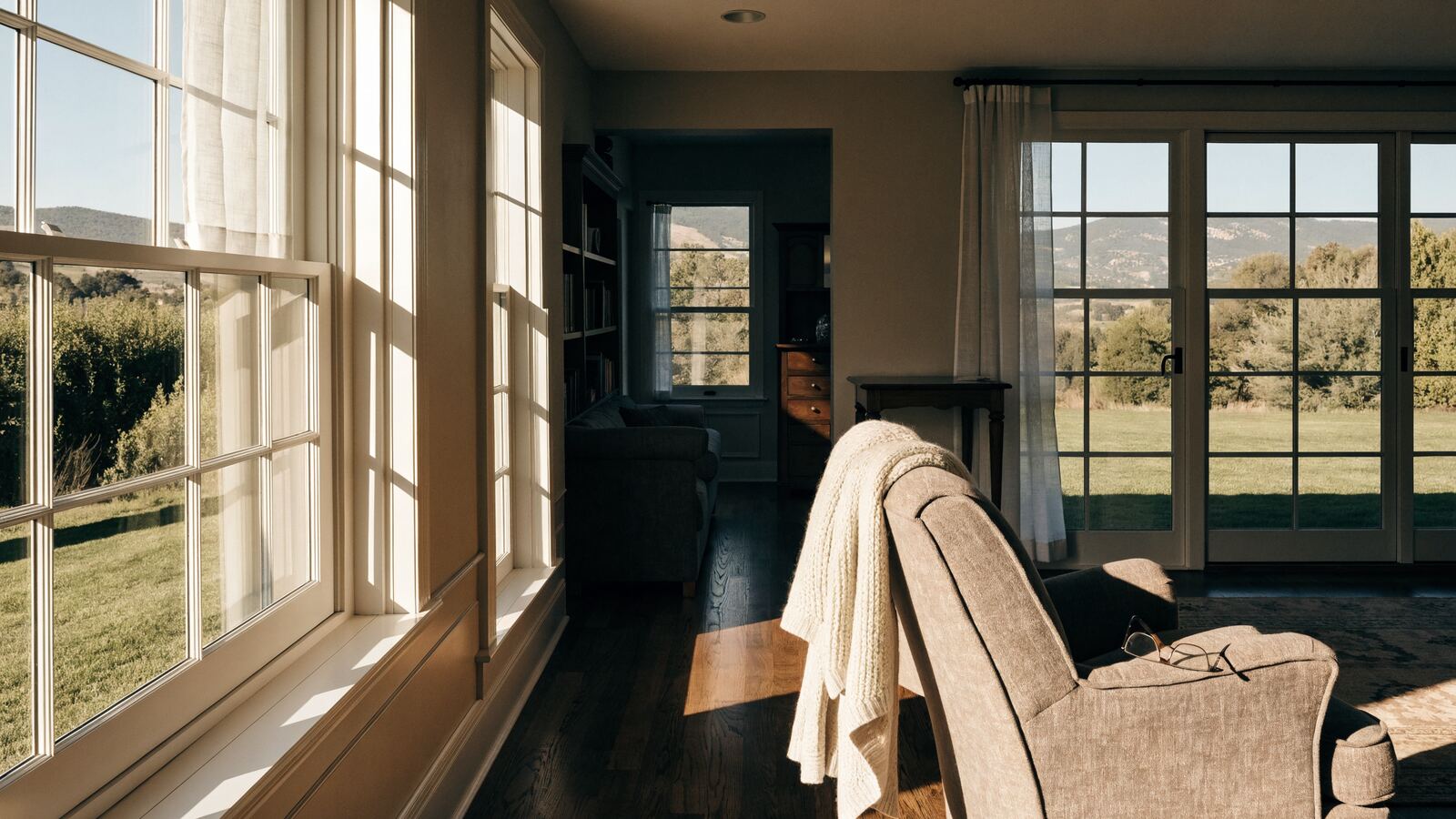 A quiet armchair with a folded cardigan in an older Colorado home